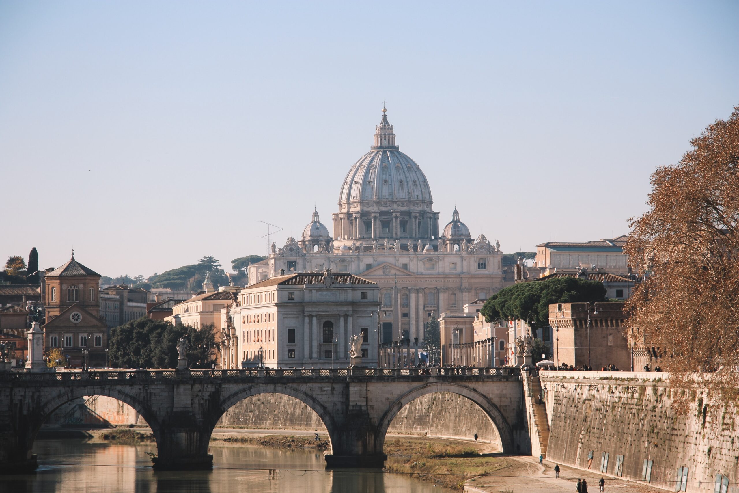 a bridge over a river with a building in the background