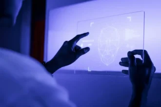 Inteligência Artificial; designer usando uma tecnologia futurista de tela de tablet digital transparente